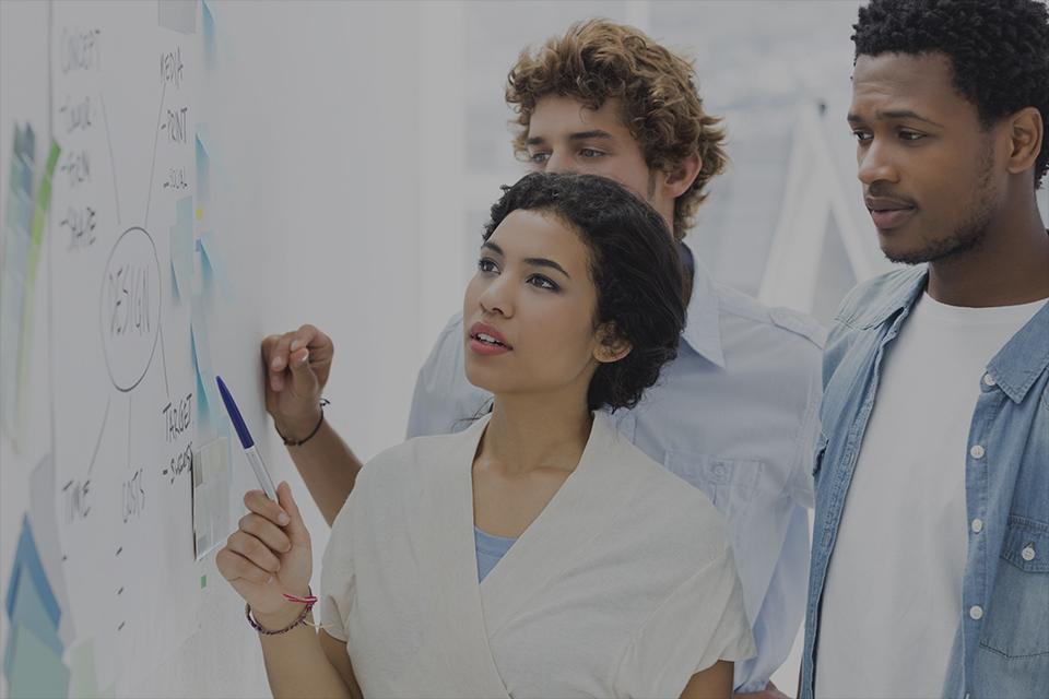 A group of people collaborating on a whiteboard.